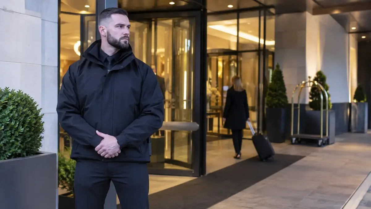 Security officer working at a hotel entrance.